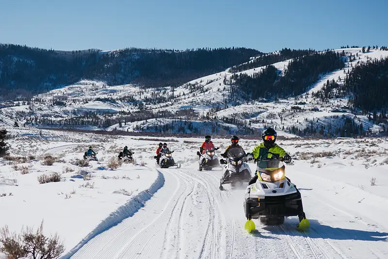 snowmobilers tour the ranch